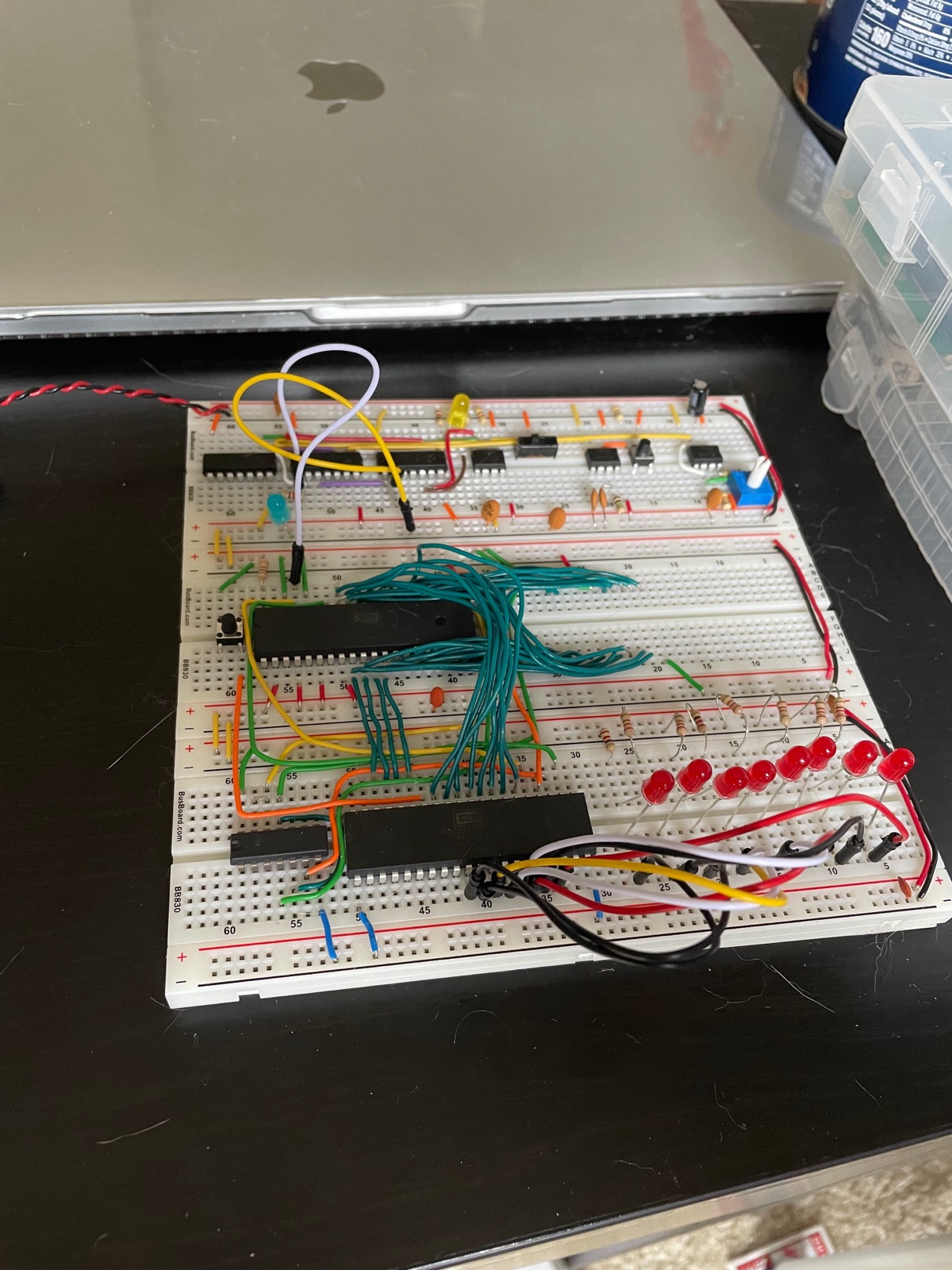 Eight red LEDs in a row with series resistors, driven by a 65C22 VIA on a breadboard, with the clock module still attached above.
